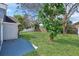 Large backyard with healthy green lawn and trees providing shade and privacy at 8630 Fort Jefferson Blvd, Orlando, FL 32822