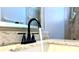 Elegant bronze bathroom faucet on a granite countertop adds a touch of luxury at 8854 Oak Landings Ct, Orlando, FL 32836