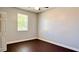 A well-lit room with hardwood floors, gray walls, and a ceiling fan at 8854 Oak Landings Ct, Orlando, FL 32836