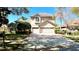 Inviting two-story home featuring a three-car garage and well-manicured lawn at 8854 Oak Landings Ct, Orlando, FL 32836