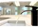 Close-up of modern bathroom faucet with running water at 8854 Oak Landings Ct, Orlando, FL 32836