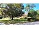 Well-maintained front yard with mature trees and lush landscaping at 8854 Oak Landings Ct, Orlando, FL 32836