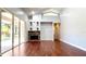 Living room featuring wood floors, a stone fireplace, and bright light at 8854 Oak Landings Ct, Orlando, FL 32836