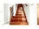 Staircase featuring hardwood steps and a black wrought iron railing at 8854 Oak Landings Ct, Orlando, FL 32836