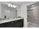 This bathroom features a double vanity with granite countertops and a modern glass-enclosed shower for a luxurious feel at 8907 Sydney Ave, Kissimmee, FL 34747