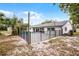 Fenced-in backyard features a pool and patio, a shed for storage, lush greenery and string lights at 8908 Turnberry Ct, Orlando, FL 32819