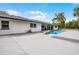 Spacious backyard featuring a pool with rock detail, a large patio area and manicured greenery at 8908 Turnberry Ct, Orlando, FL 32819