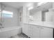 Bathroom features dual sink vanity with tub and shower combo and neutral walls at 8908 Turnberry Ct, Orlando, FL 32819