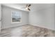 Bright bedroom features sleek ceiling fan, wood-look floors, and natural light from the window at 8908 Turnberry Ct, Orlando, FL 32819