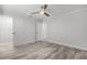 Bright bedroom features ensuite bath, walk-in closet, ceiling fan, and stylish wood-look floors at 8908 Turnberry Ct, Orlando, FL 32819