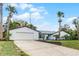 Charming single story home with a two car garage, nicely landscaped yard and mature palm trees at 8908 Turnberry Ct, Orlando, FL 32819