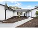 Inviting front yard with a patterned walkway that leads to the entrance, and a landscaped garden at 8908 Turnberry Ct, Orlando, FL 32819