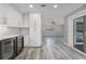 Modern kitchen with white cabinets, sleek countertops, a wine refrigerator, and an open view into the home's living spaces at 8908 Turnberry Ct, Orlando, FL 32819