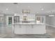 Bright, open kitchen with white cabinets, stainless appliances, and large center island at 8908 Turnberry Ct, Orlando, FL 32819