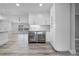 Bright kitchen featuring dual wine coolers built into white cabinets with granite counter tops and tile flooring at 8908 Turnberry Ct, Orlando, FL 32819