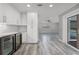 Bright kitchen boasts white cabinets, wine fridge, and seamless flow to the outdoors at 8908 Turnberry Ct, Orlando, FL 32819