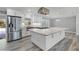 Gorgeous kitchen featuring stainless appliances, granite counters and island, and white cabinets at 8908 Turnberry Ct, Orlando, FL 32819