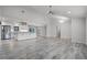 Open-concept living room featuring wood-look tile floors and ample natural light at 8908 Turnberry Ct, Orlando, FL 32819