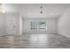 Bright and airy living room featuring wood-look tile flooring and a large window at 8908 Turnberry Ct, Orlando, FL 32819