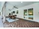 This covered patio features wood flooring, ceiling fans, and dining table, perfect for outdoor living at 8908 Turnberry Ct, Orlando, FL 32819