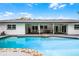 Backyard pool with rock detail near a covered porch complete with a ceiling fan and outdoor seating at 8908 Turnberry Ct, Orlando, FL 32819