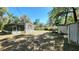 Wide shot of a single-story home showing the backyard with trees at 20144 Se 156Th St, Umatilla, FL 32784