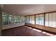 Bright sunroom with multiple windows, wood laminate flooring, and ample natural light at 20144 Se 156Th St, Umatilla, FL 32784