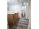 Bathroom vanity with wooden cabinets, gray floors and a view of the toilet and shower at 11618 Churchill St, Orlando, FL 32817