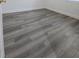 Cozy bedroom with new gray wood flooring, white trim, and bright natural light at 11618 Churchill St, Orlando, FL 32817