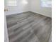 Bedroom features new flooring, neutral paint, and natural lighting through bright windows at 11618 Churchill St, Orlando, FL 32817