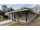 Charming single-story home with a covered porch and landscaped flowerbeds at 11618 Churchill St, Orlando, FL 32817