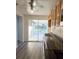 Well-lit kitchen with a stainless steel sink, and sliding glass door to the backyard at 11618 Churchill St, Orlando, FL 32817