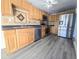 Eat-in kitchen with stainless steel appliances, wood cabinetry, and tile backsplash at 11618 Churchill St, Orlando, FL 32817