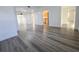 Spacious living area with hardwood floors leading to the kitchen and bedroom at 11618 Churchill St, Orlando, FL 32817