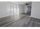 Bright and airy living room boasts new floors and natural light from large windows at 11618 Churchill St, Orlando, FL 32817