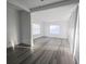 Open-concept living room featuring new flooring, neutral paint, and bright natural light at 11618 Churchill St, Orlando, FL 32817