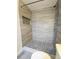 An updated tiled shower with a rainfall showerhead and niche, with mosaic tile accents at 11618 Churchill St, Orlando, FL 32817
