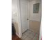Hallway with neutral wall color, ceramic tile, and white trim at 1168 Woodman Way, Orlando, FL 32818