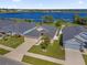Aerial view of the home, showcasing the lake and neighboring houses in the community at 1200 Kellogg Dr, Tavares, FL 32778