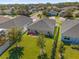 Aerial view of a home with a well-maintained lawn, patio with seating, and neighborhood at 1200 Kellogg Dr, Tavares, FL 32778