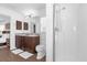 Bathroom featuring a double vanity, framed mirror, and walk in shower at 1200 Kellogg Dr, Tavares, FL 32778