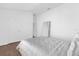 Minimalist bedroom with wood floors, a full-length mirror, and ample space at 1200 Kellogg Dr, Tavares, FL 32778