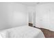 Simple bedroom with a view through an open doorway, featuring wood floors at 1200 Kellogg Dr, Tavares, FL 32778