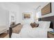 Bright bedroom with a view into an adjacent living space featuring art and neutral decor at 1200 Kellogg Dr, Tavares, FL 32778