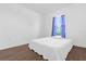 Bright bedroom with wood floors and a large window with blue curtains at 1200 Kellogg Dr, Tavares, FL 32778