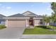 Charming single-story home featuring a two-car garage and well-manicured lawn at 1200 Kellogg Dr, Tavares, FL 32778