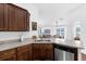 Kitchen area featuring a stainless steel dishwasher, countertop and view into other living areas at 1200 Kellogg Dr, Tavares, FL 32778