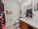Charming bathroom with Mickey Mouse shower curtain and ample vanity space at 1206 Bella Cara Ct, Davenport, FL 33896