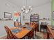 Traditional dining area featuring a wooden table set for four, vintage decor, and ample natural light at 1206 Bella Cara Ct, Davenport, FL 33896