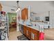 Well-lit kitchen with wood cabinets and stainless steel appliances, seamlessly connected to the dining and living areas at 1206 Bella Cara Ct, Davenport, FL 33896